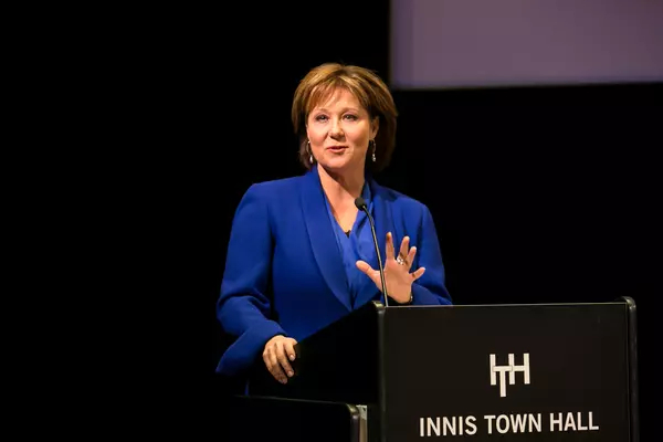 Christy Clark standing at a podium addressing a crowd